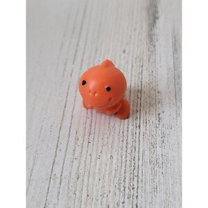 Orange miniature rubber Trex dinosaur toy figure